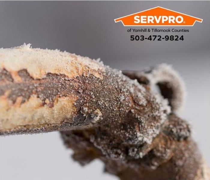 A frozen and corroded pipe is shown.